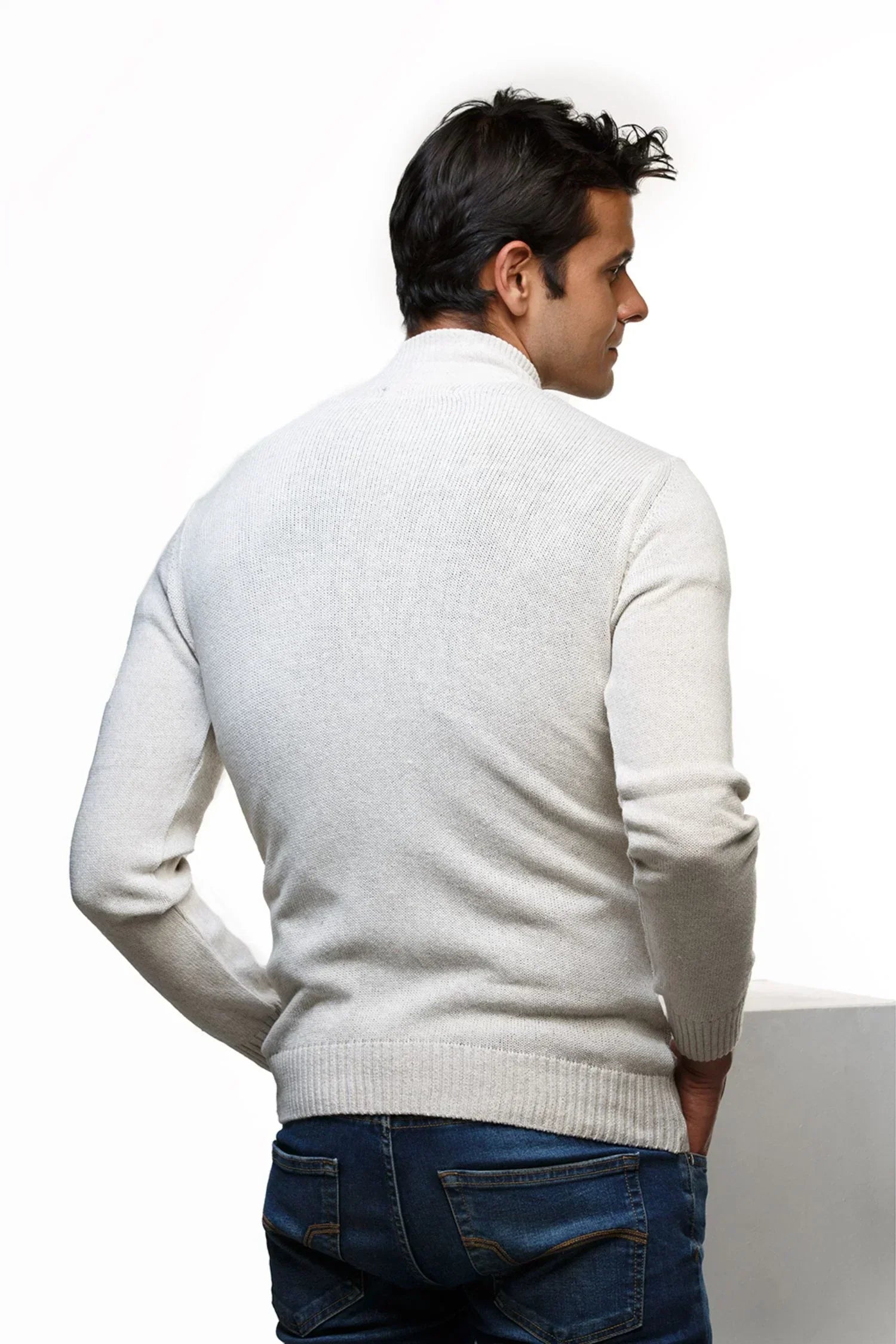 Hombre con suéter tejido de punto beige y jeans, moda casual masculina